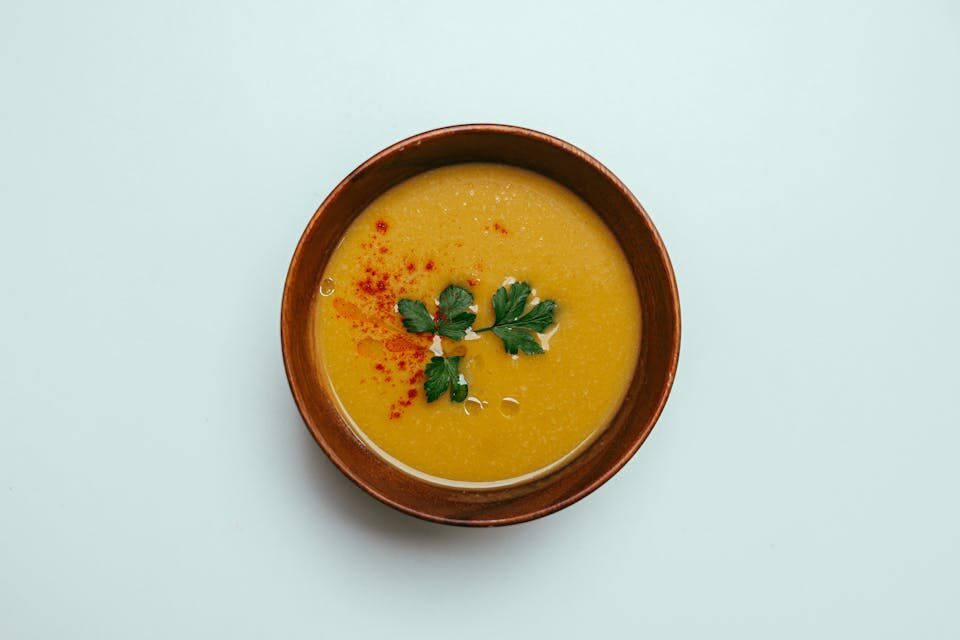 Couple enjoying warm lentil soup together at cozy dinner table - family comfort food tradition