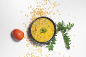 Hearty lentil soup with sausage and kale in a white ceramic bowl, garnished with fresh parsley - easy one-pot comfort food recipe