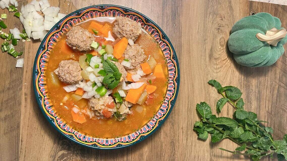 Fresh ingredients for Italian wedding soup - ground meat, herbs, carrots, celery