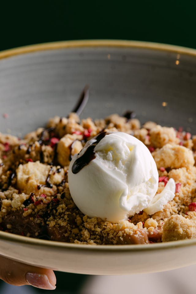 Slow Cooker Apple Crisp served warm with vanilla ice cream melting on top - perfect fall dessert