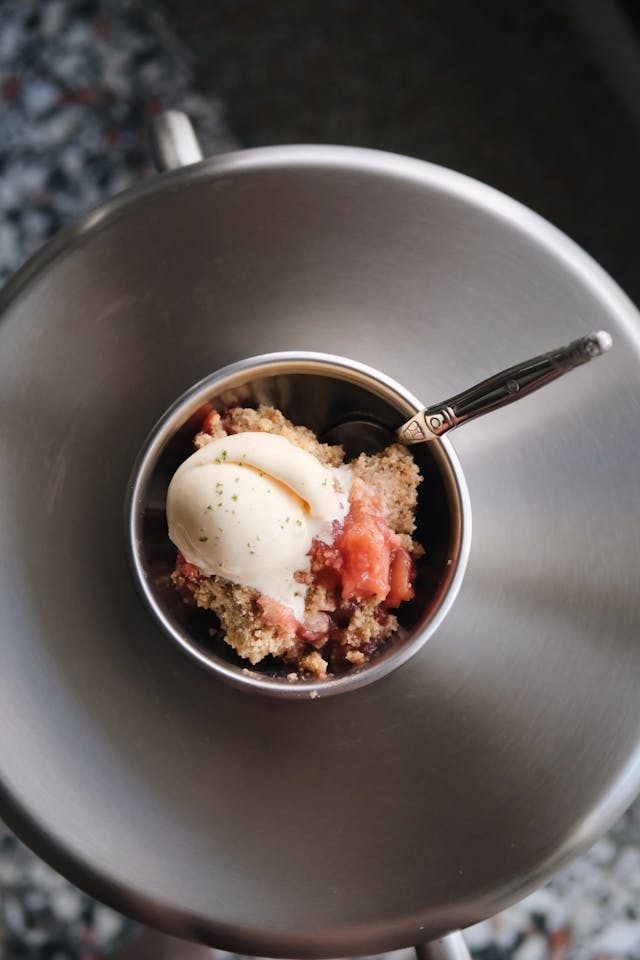 Slow Cooker Apple Crisp served warm with vanilla ice cream melting on top - perfect fall dessert