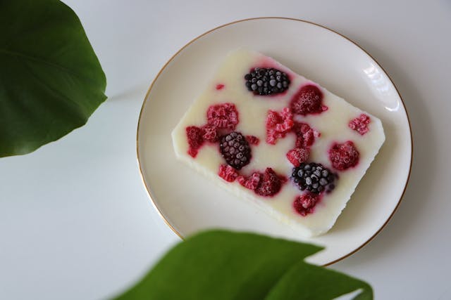 Frozen yogurt berry bark broken into pieces with strawberries and blueberries - make-ahead lunchbox dessert