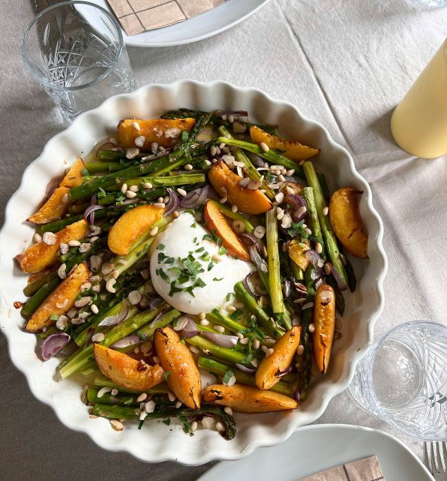 Grilled peach salad with burrata, prosciutto, and arugula on white platter - quick healthy summer recipe