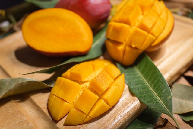 Ripe Alphonso mangoes on cutting board ready for lassi