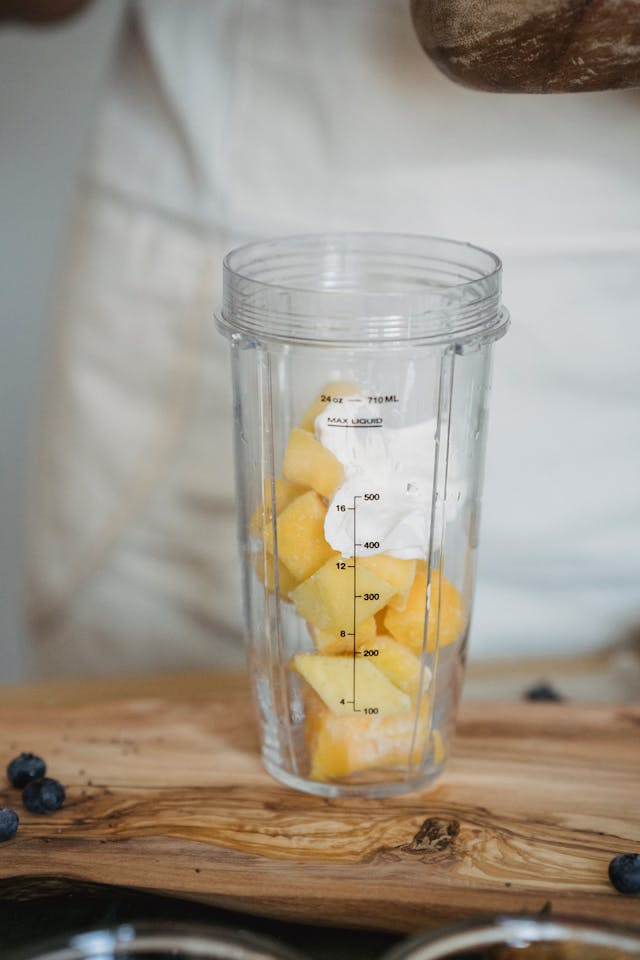 Ingredients for mango lassi in a blender before mixing