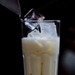 Traditional glass of Namkeen Lassi garnished with mint leaves, iced and cumin