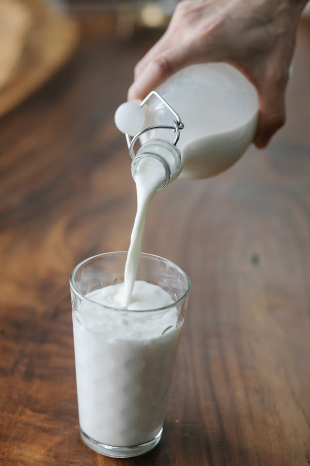 Cold milk being poured into glass for Namkeen Lassi recipe