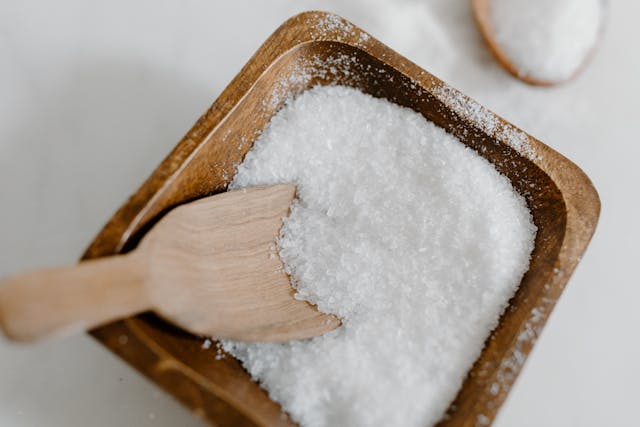 Salt being added to Namkeen Lassi for electrolyte balance and flavor