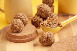Assorted no-bake energy bites and healthy lunchbox desserts on a wooden board
