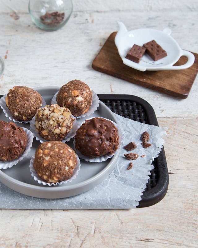 No-bake oatmeal energy bites stacked on white plate - healthy school lunchbox dessert for kids