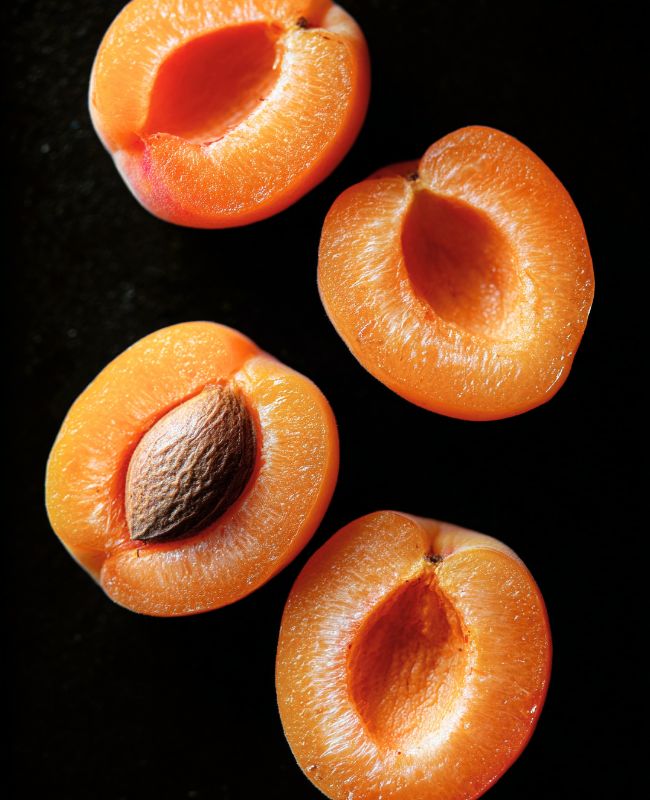 Fresh peaches grilling on BBQ with golden grill marks - caramelized summer fruit
