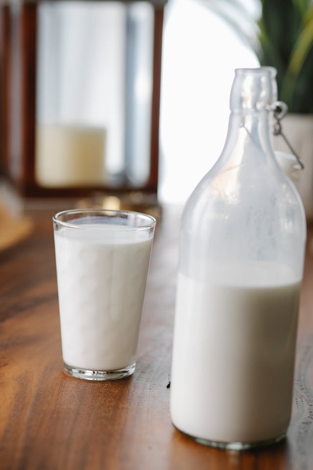 milk being added to yogurt for sweet lassi recipe
