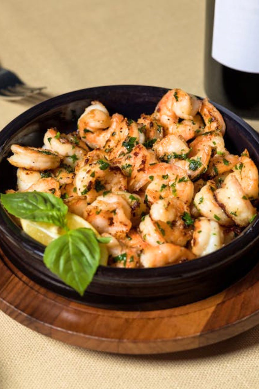 Shrimp scampi recipe card image showing ingredients like shrimp, butter, garlic, lemon, and parsley arranged on a wooden board.