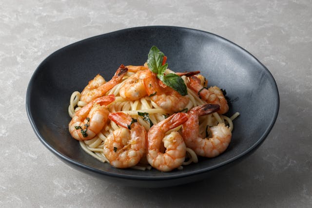 Delicious shrimp scampi tossed with spaghetti noodles, garlic butter sauce, and sprinkled with parmesan cheese.